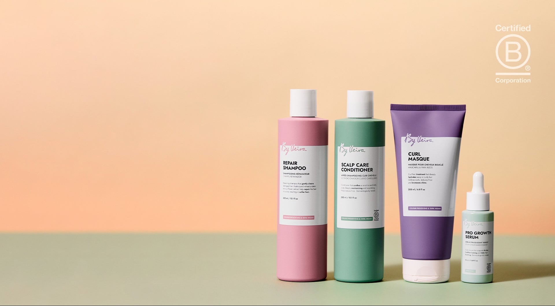 Set of skincare products including bottles and a tube on a gradient background